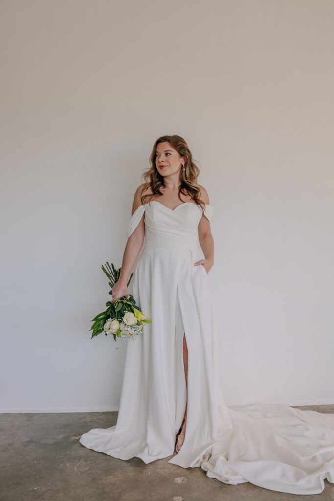7749-Stella York-Essense of Australia-Pure Bridal-Sexy-Modern-wedding dress stores Edmonton-Wedding gown-Satin-Aline-Off the shoulder sleeves-slit