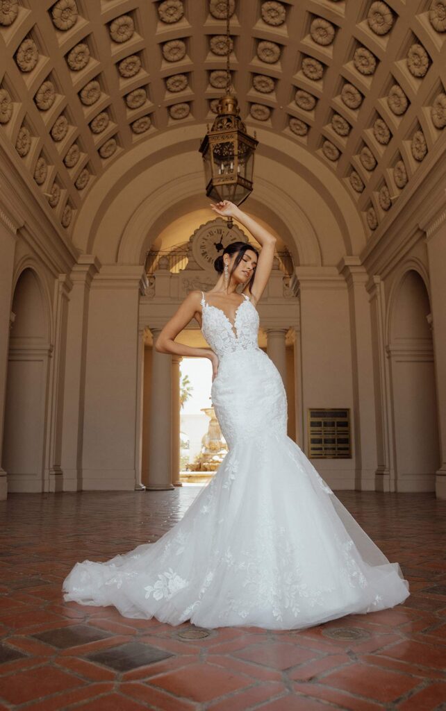 D3484-Essense of Australia-Pure Bridal-Yeg Bridal-Wedding gown-Mermaid. Elegant and modern, Style D3484 combines timeless elegance and glamour. With a touch of sparkle, the beaded spaghetti straps meet a natural edge of rosette lace for a romantic appeal. Plunging into the sheer bodice, an ultra-flattering deep V-neckline is outlined in charming botanical lace. From the deep side cutouts, a low illusion lace back adds a touch of floral appeal over bare skin for a sexy low back detail. To finish, the luxe form-fitting silhouette blends into a fit and flare skirt made with frothy layers of tulle and scattered lace appliqus completing this chic allover lace wedding dress.