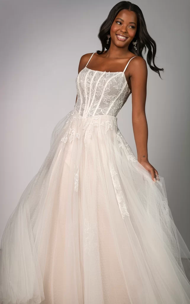 SY8114-Stella York-Pure Bridal, Edmonton bridal shop, Edmonton wedding dress. Both glamorous and romantic, Style SY8114 is a dreamy matte lace ballgown designed for the modern princess bride. Delicate spaghetti straps frame a sheer bodice with exposed boning, beautifully adorned with oversized organza lace appliqus. From the classic basque waist, scattered floral lace drifts down the airy tulle skirt, enhancing the enchanting ballgown silhouette. Blending timeless elegance with modern charm, this breathtaking wedding dress is the ideal statement for the bride who desires a fairytale-worth look with a contemporary edge. This gown is also available in plus sizes.
